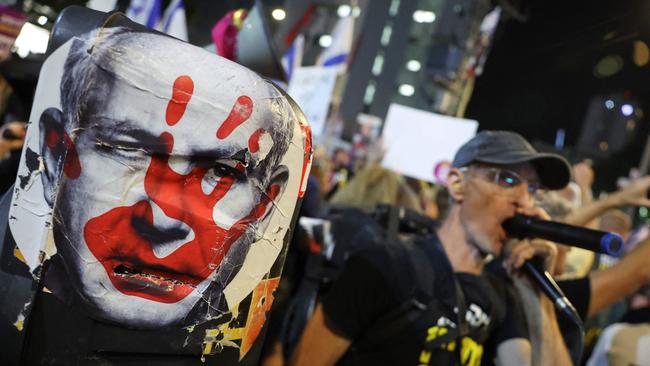 Demonstrators in tel Aviv on Saturday raise placards and chant slogans during an anti-government protest calling for action to secure the release of Israeli hostages. Picture: AFP