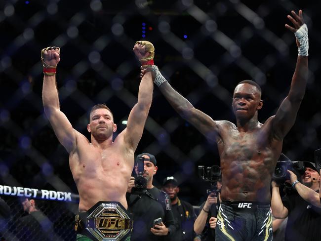 Dricus Du Plessis of South Africa has his arm raised by Israel Adesanya of Nigeria after winning the Middleweight championship fight by submission during UFC 305. Picture: Paul Kane/Getty Images