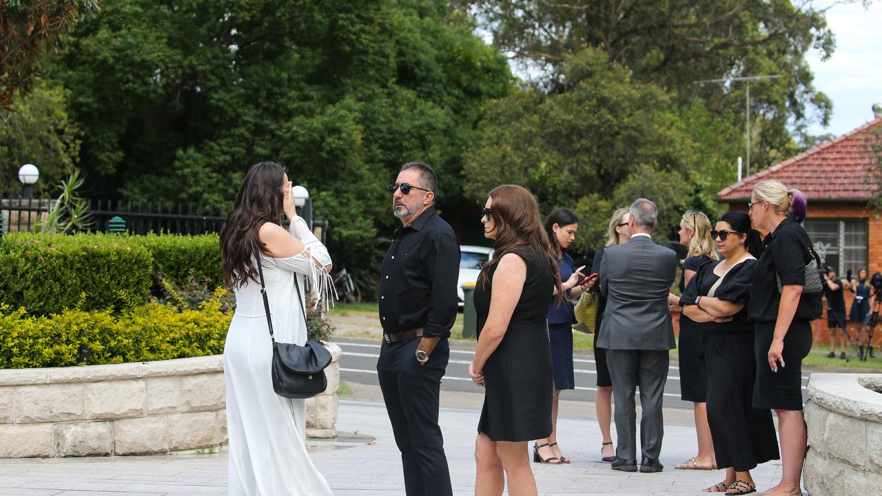 Godmother Martina Bekic (wearing white) of young Nicholas arrives and is greeted by Friends and family at the Funeral for Seaworld helicopter crash victim Vanessa Tadros at St John the Beloved Church, Mt Druitt. Picture NCA Newswire / Gaye Gerard