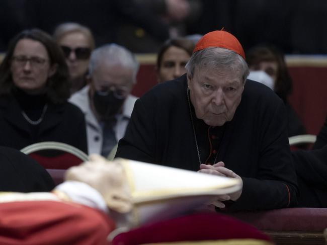 Cardinal George Pell prays near the body of the late Pope Emeritus Benedict XVI (Joseph Ratzinger) lying in state in the Saint Peter Basilica.