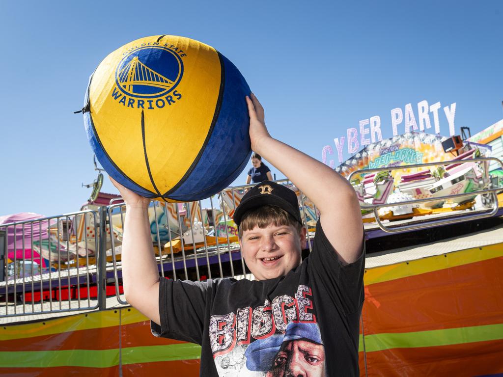 Brax Byrne shows the giant basketball won at sideshow alley at the Toowoomba Royal Show, Friday, April 19, 2024. Picture: Kevin Farmer