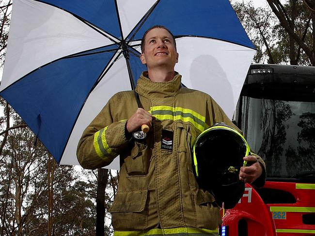 Fire and Rescue NSW Nowra firies Dave Holman (L) and Paul Sullivan (R) pictured in the fire ground on Forest Rd in Comberton eagerly awaiting the forecast rains to arrive and help douse many of the fires that have been burning across the state. Picture: Toby Zerna