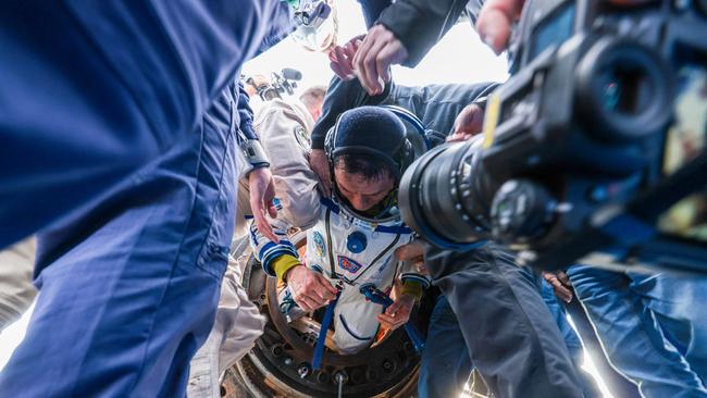 Frank Rubio is helped from the capsule on Wednesday. Picture: NASA via AFP