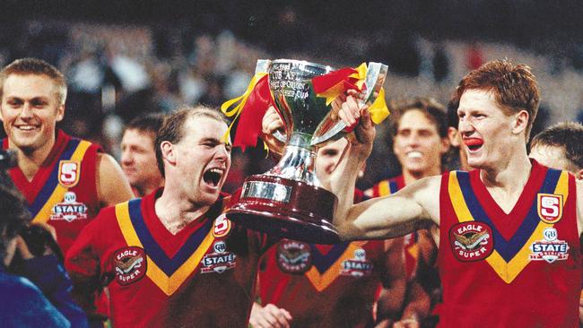 Matthew Robran, Andrew Jarman and Ben Hart lead SA team on victory lap at the MCG in 1993. Picture: Ray Titus