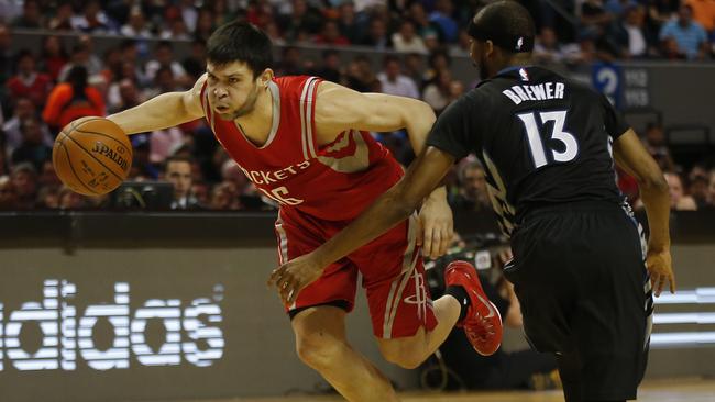 Houston Rockets' Kostas Papanikolau, left, drives past Minnesota Timberwolves' Corey Brewer.