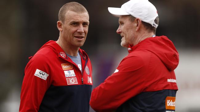 Melbourne coach Simon Goodwin talks to assistant coach Brendan McCartney.