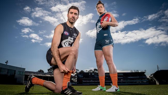 Kade Simpson and Brianna Davey model Carlton’s orange socks. Picture: Jake Nowakowski