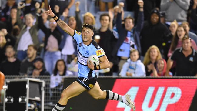 Bronson Xerri celebrates as he runs in to score a try for the Sharks. Picture: AAP