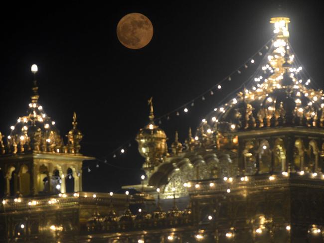 The ‘supermoon’ rises over the Sikh Shrine, the Golden Temple in Amritsar on November 14, 2016. Picture: AFP PHOTO / NARINDER NANU