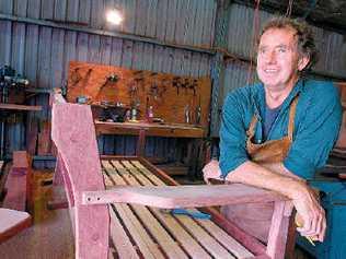 Good wood: Adrian Williamson leaves minimal carbon footprint in the production of Nimbin Garden Furniture. His tools are powered by solar panels on the roof and he uses recycled timber. Picture: Cathy Adams