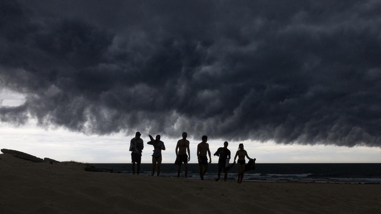 People leave the water at Nobbys Beach after advice from the lifeguard due to lightning strikes in Newcastle, Australia. Picture: Jenny Evans/Getty Images
