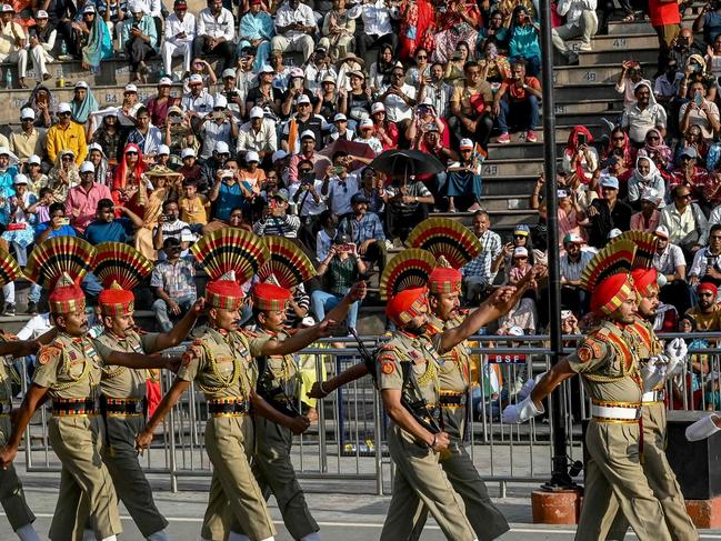 Indian Border Security Force (BSF) personnel perform during the beating retreat ceremony at the border gates of India and Pakistan, at the Wagah border post, about 35 km from Amritsar on April 25, 2025. India and Pakistan are locked in an escalating diplomatic war of words after New Delhi said Islamabad was linked to a militant attack on tourists in Indian-administered Kashmir this week. Both sides have cancelled visas for Indian and Pakistani nationals respectively and ordered them to leave, before both shut their busiest border crossing in Punjab. (Photo by Narinder NANU / AFP)