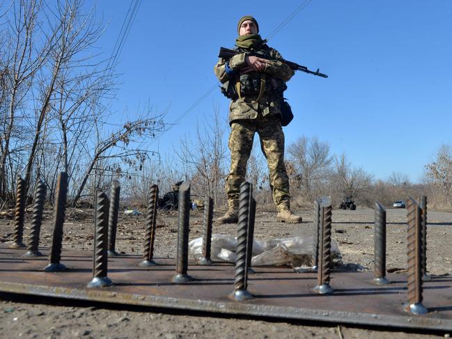 A serviceman of Ukrainian military forces stands guard at a checkpoint, where they hold a position near Kharkiv. Picture: AFP