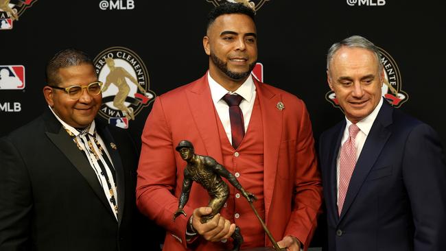 Nelson Cruz of the Tampa Bay Rays is presented the Roberto Clemente Award by Luis Clemente and MLB Commissioner Rob Manfred prior to Game Two of the World Series. Picture: Getty Images.