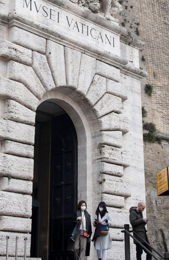 Tourists wearing protective masks at the exit of the Vatican Museums at the Vatican. Picture: AFP