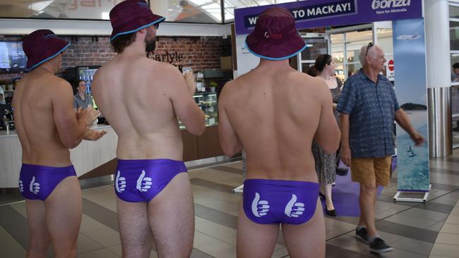 Mackay Cutters players Kabe Bone, Alfie Schultz, and Asher O'Donnell welcome passengers on Bonza's first Sunshine Coast to Mackay flight on February 14, 2022. Photo: Zoe Devenport