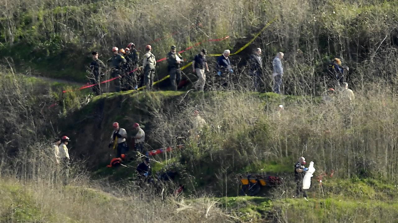 Investigators work the scene of a helicopter crash that killed former NBA basketball player Kobe Bryant, his 13-year-old daughter, Gianna, and several others Monday, Jan. 27, 2020, in Calabasas, Calif. (AP Photo/Mark J. Terrill)