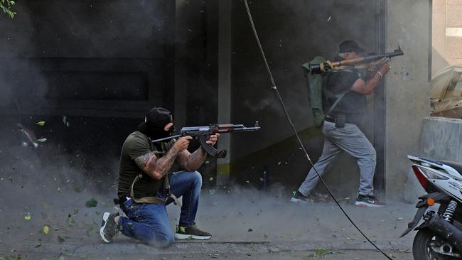 Shiite fighters from the Hezbollah and Amal movements take aim with a Kalashnikov assault rifle and a rocket-propelled grenade launcher in the southern suburb of Beirut. Picture: AFP