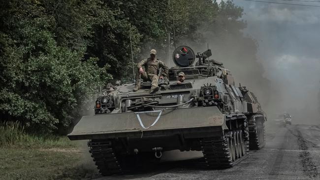 Ukrainian servicemen ride a military vehicle near the Russian border in Ukraine’s Sumy region. Picure: Reuters/Viacheslav Ratynskyi