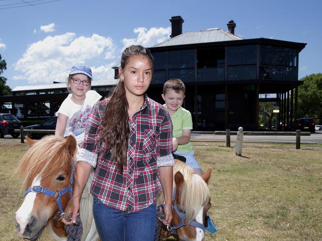 Pony handler Grace Takacs with ponies Arrow and Woody take Jesscia, 7, and Harrison, 6, O'Grady for a ride Woolwich Pier Hotel. Photo: Adam Ward