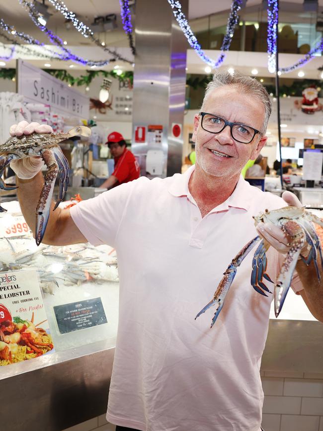 David Pollock buys some blue swimmer crabs — just some of the 350 tonnes of seafood expected to be sold at Sydney Fish Markets this festive season. Picture: Rohan Kelly