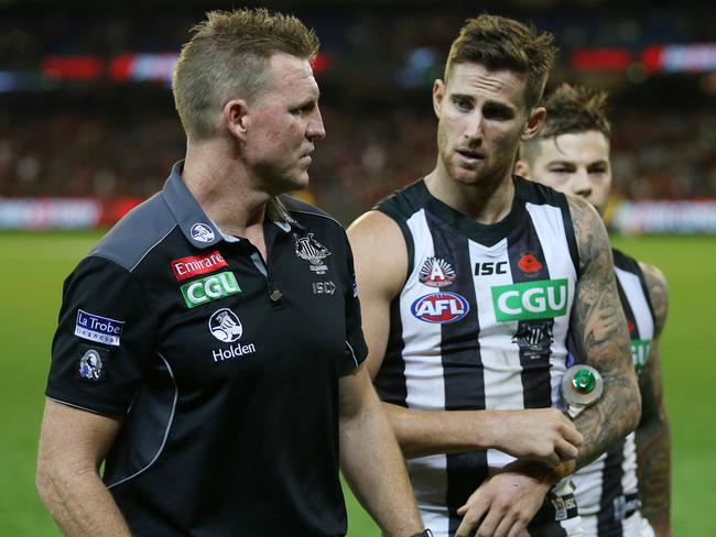 Nathan Buckley walks off the ground with his players following the loss to Essendon. Photo: Michael Klein