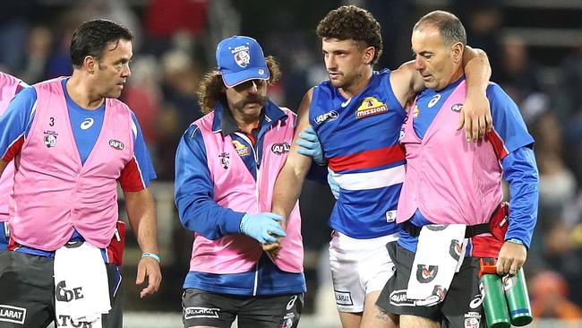 Trainers help a groggy Tom Liberatore.