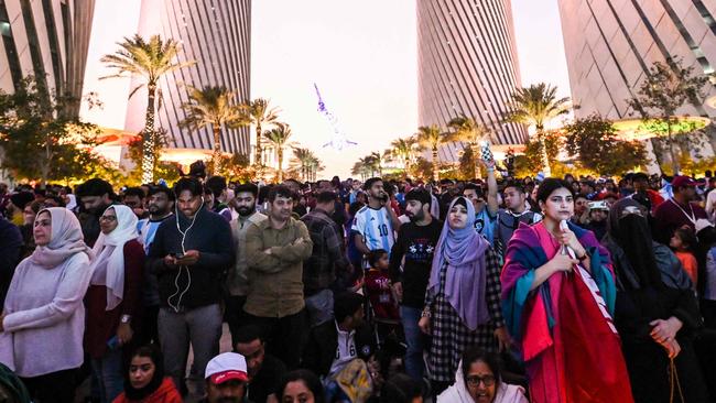 Workers gather at Lusail Boulevard to watch the Qatar 2022 World Cup football final match between Argentina and France, in Lusail on December 18, 2022. (Photo by INA FASSBENDER / AFP)