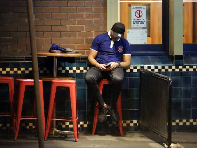 A Bulldogs player leaning on the wall of the hotel after falling asleep during the Bulldogs Mad Monday Celebrations at the Harbour View Hotel at The Rocks. Picture: Christian Gilles