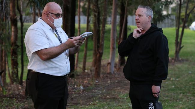 An Anglicare chaplain talks with Anthony Bowe, right, whose mother is a resident of Newmarch House in western Sydney. Picture: Jane Dempster