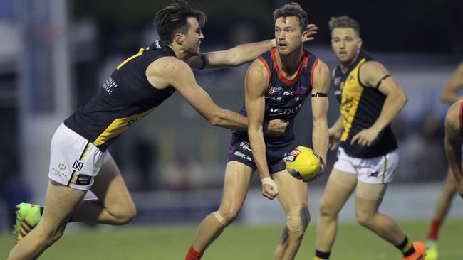 Glenelg's Liam McBean tackles Norwood’s Zac Richards in Round 1. Picture Dean Martin