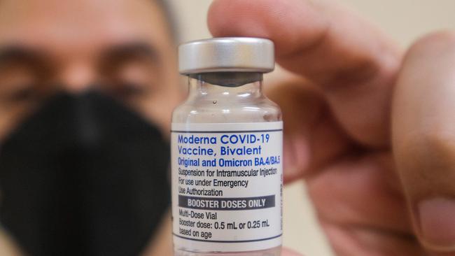 A pharmacist holds up a vial of the Moderna Covid-19 vaccine, Bivalent, at AltaMed Medical clinic in Los Angeles, California, on October 6, 2022. (Photo by RINGO CHIU / AFP)