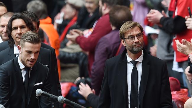 Liverpool's German manager Jurgen Klopp (R) arrives with his players to attend the memorial service at Anfield.