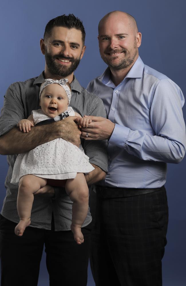 Marco and Stanley Oliveira-Gray and seven month old baby Annabelle, who was born with the help of Stan's two sisters. Pic Mark Cranitch.