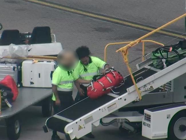 Uinisitoni Tolutau removing the meth bag from a plane that landed in Sydney from Canada on March 6 2019. Picture: Supplied