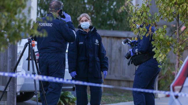 Forensic investigators collect evidence. Picture: Brendan Beckett