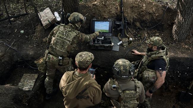 Pilots of the Ukraine’s Sharp Kartuza division monitor drones for a combat flight in the Kharkiv region, 8km from the Russian border. Picture: Getty Images