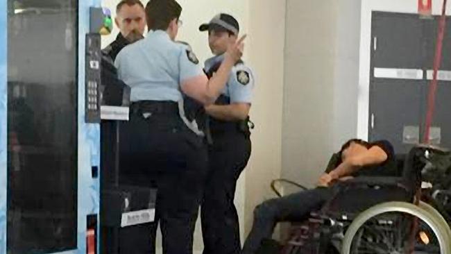 A man who is claimed to be Grant Hackett slumped in a wheelchair following his flight to Melbourne.