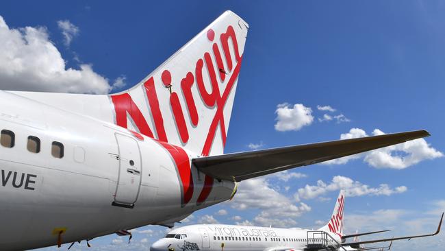 Grounded Virgin Australia aircraft are seen parked at Brisbane Airport. Picture: Darren England