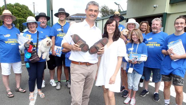 Hermann Vorster and his wife Melissa with worn-out shoes and his volunteers at Burleigh Heads on election day. Picture by Richard Gosling