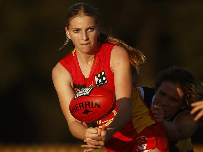 Sunny Lappin of the Suns handballs while being tackled in the Coates Talent League Girls match against Oakleigh Chargers. Picture: Daniel Pockett/AFL Photos/via Getty Images.