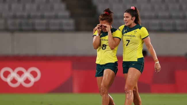 Madison Ashby and Charlotte Caslick of Team Australia look dejected at full time in the Quarterfinal match between Team Fiji and Team Australia during the Rugby Sevens on day seven of the Tokyo 2020 Olympic Games at Tokyo Stadium on July 30, 2021 in Chofu, Tokyo, Japan. (Photo by Dan Mullan/Getty Images)