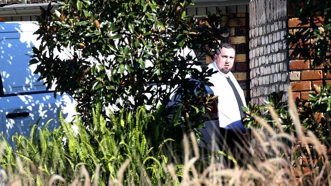 Police at the scene where the 20-year-old was arrested in the front yard of his Metford home. Picture: Peter Lorimer