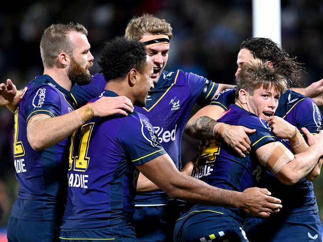 SUNSHINE COAST, AUSTRALIA - JUNE 19: Harry Grant of the Storm is congratulated by team mates after scoring a try during the round 15 NRL match between the Melbourne Storm and the Wests Tigers at Sunshine Coast Stadium, on June 19, 2021, in Sunshine Coast, Australia. (Photo by Bradley Kanaris/Getty Images)