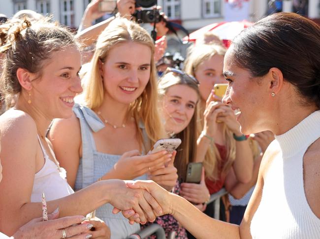 DUSSELDORF, GERMANY - SEPTEMBER 06: Meghan, Duchess of Sussex is greeted by well-wishers outside the town hall during the Invictus Games Dusseldorf 2023 - One Year To Go events, on September 06, 2022 in Dusseldorf, Germany. The Invictus Games is an international multi-sport event first held in 2014, for wounded, injured and sick servicemen and women, both serving and veterans. The Games were founded by Prince Harry, Duke of Sussex who's inspiration came from his visit to the Warrior Games in the United States, where he witnessed the ability of sport to help both psychologically and physically. (Photo by Chris Jackson/Getty Images for Invictus Games Dusseldorf 2023)