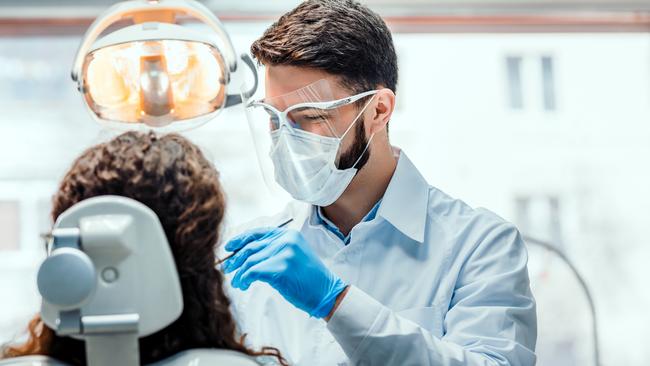 Generic dentist photo  for SAweekendDentist working in dental clinic with patient in the chair.