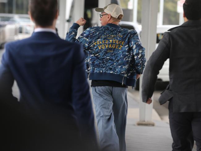 ‘I’m here and I’m off’...van Damme legs it at Sydney Airport today. Picture: Pic John Grainger