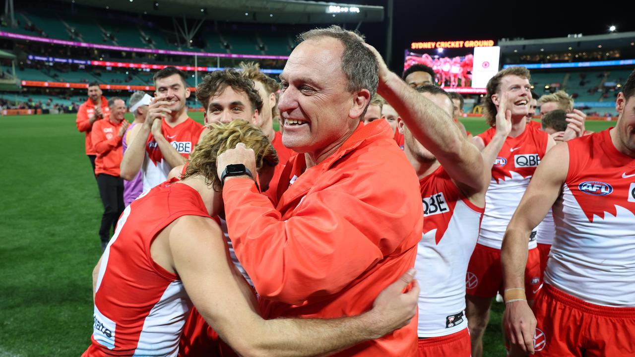 SYDNEY, AUSTRALIA - JULY 13: Swans head coach John Longmire celebrates with Swans players after victory during the round 18 AFL match between Sydney Swans and Western Bulldogs at Sydney Cricket Ground, on July 13, 2023, in Sydney, Australia. (Photo by Mark Metcalfe/AFL Photos/via Getty Images)