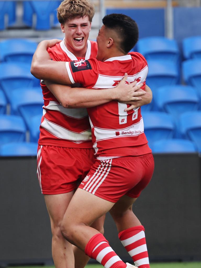 NRL National Schoolboys Cup final at CBUS Stadium between Palm Beach Currumbin and Patrician Blacktown Brothers. The Red Army and Palm Beach Currumbin 's Beau Hartmann scores the winning try and celebrates with team mates.. .Picture Glenn Hampson