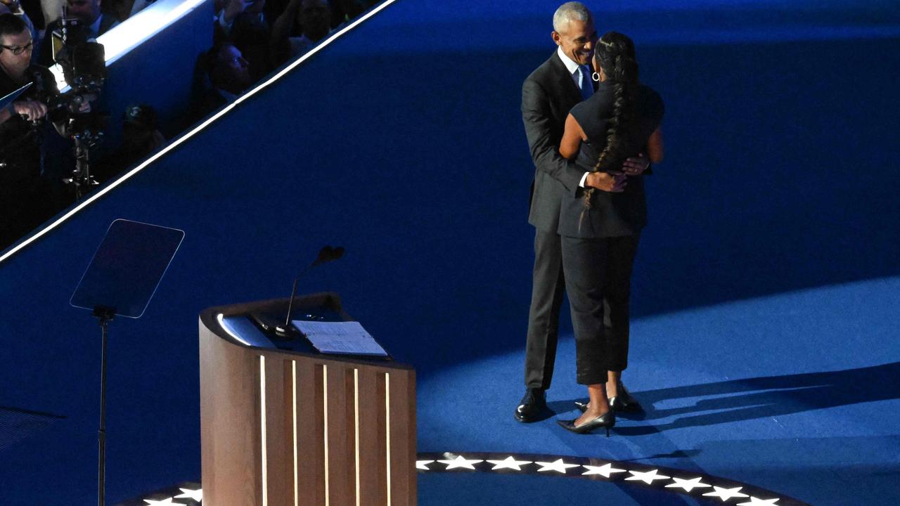 Barack Obama hugs Michelle Obama. Picture: AFP.